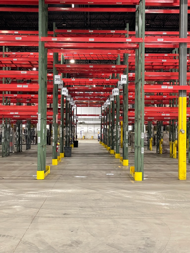 Warehouse shelving with stacked pallets